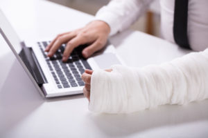 injured man on laptop